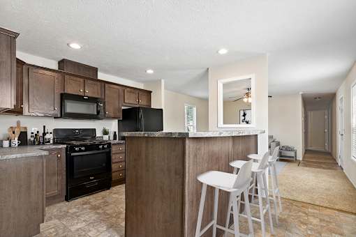 model kitchen with barstools  at Candlelight Village Manufactured Home Community in Sauk, IL