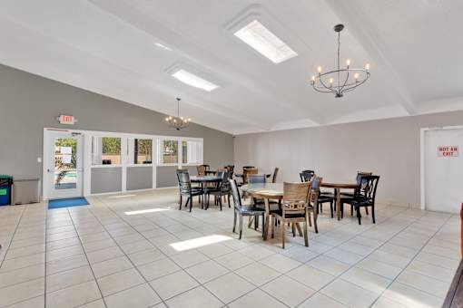 A dining room with a table set for six people.
