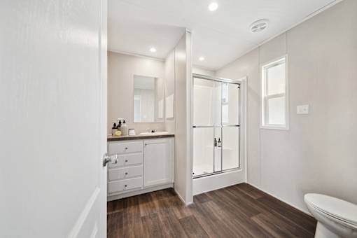 Model bathroom vanity and shower at Cedar Ridge Manufactured Home Community  in Wichita, Kansas