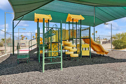Playground with sun shade at Verde Plaza Manufactured Home Community in Tucson, Arizona