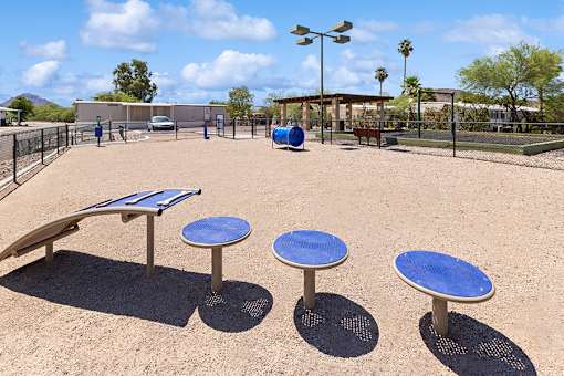 Fenced dog park with agility equipment at Verde Plaza Manufactured Home Community in Tucson, Arizona