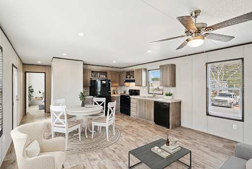 A modern kitchen with a dining table and chairs.