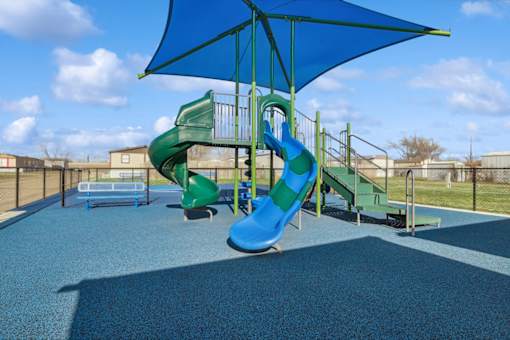 Community playground with sun cover at Cedar Ridge Manufactured Home Community  in Wichita, Kansas