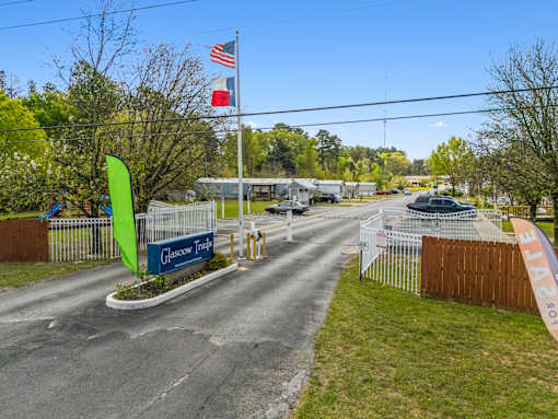 The entrance to Clasow Travel with a green flag and a sign.