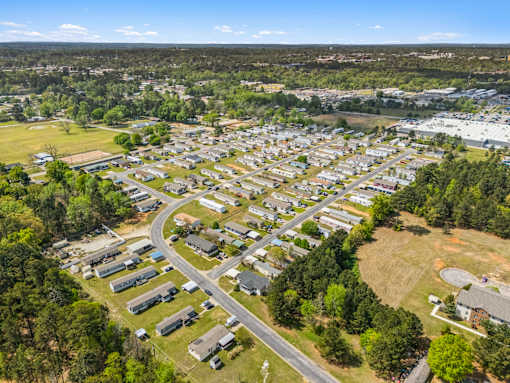 A bird's eye view of a residential area with houses and a road.