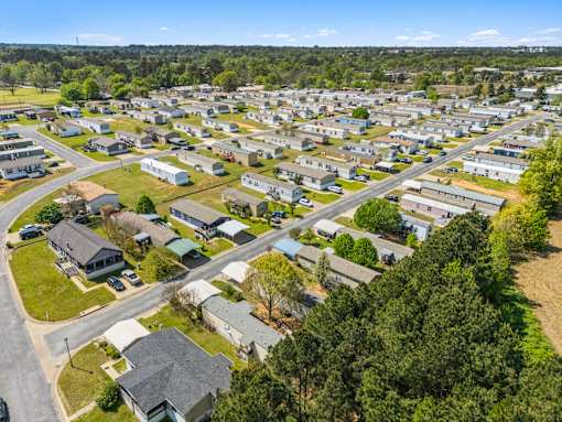 A bird's eye view of a residential area with houses and trees.