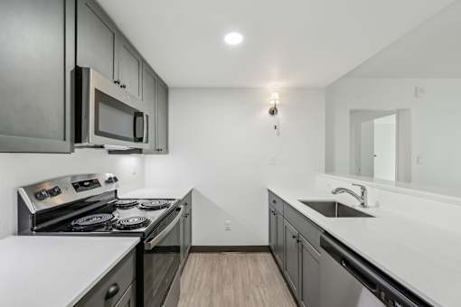 A modern kitchen with a stove top oven and microwave.