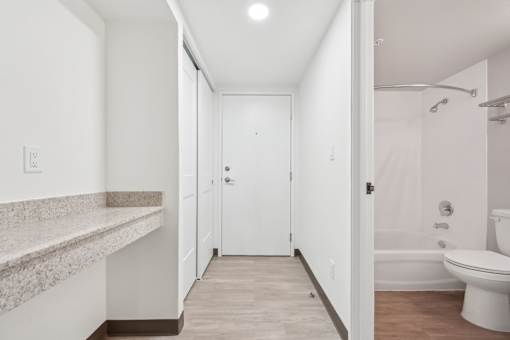 A white bathroom with a toilet, sink, and bathtub.