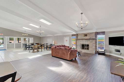 A spacious living room with a fireplace and a couch.