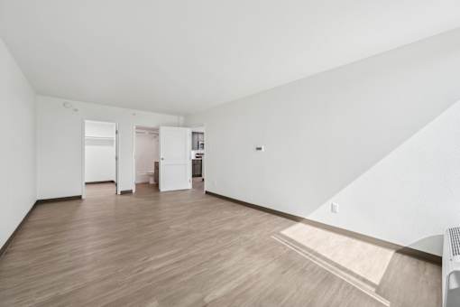 A room with wooden floors and white walls.