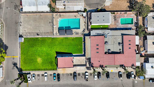 A large grassy area in the middle of a parking lot.