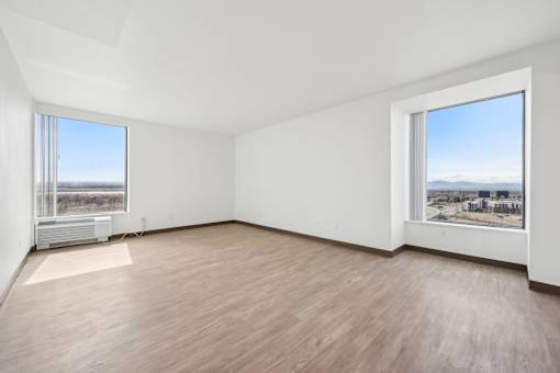 Empty room with a view of the cityscape outside the window.