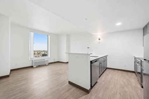 A kitchen with white appliances and wooden floors.
