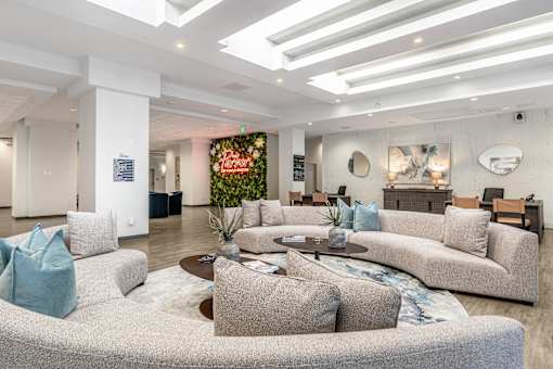 A modern living room with a grey sofa and a coffee table.
