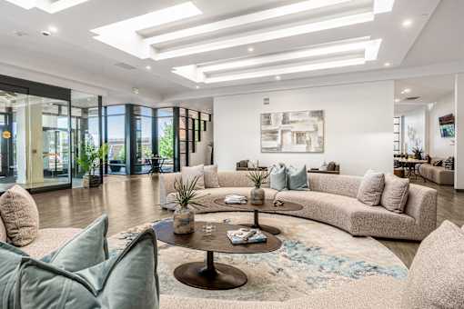 A modern living room with a large sectional sofa and a coffee table.