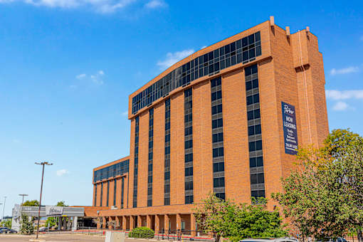 A large orange building with a sign that reads "Fairmont Leawood".