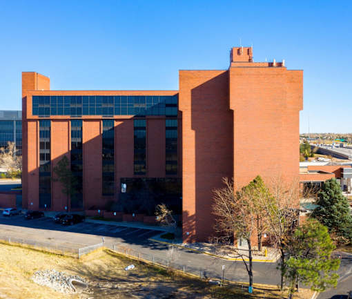 a large brick building with a blue sky in the background