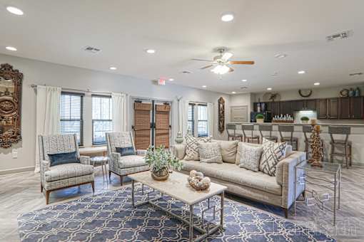 A Living Room With a Grey Couch at Arbours at Pierce Creek, Mobile, AL