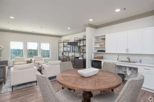 A modern kitchen with a dining table and chairs.