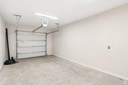 A room with a white wall and a white door.