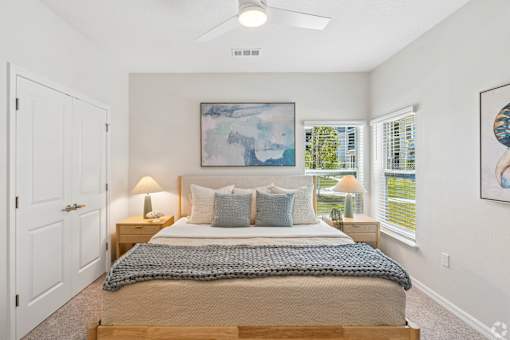 A bedroom with a bed, pillows, and a blanket.