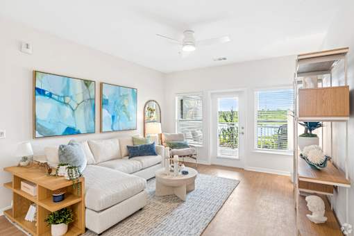 A living room with a white couch, a coffee table, and a painting on the wall.