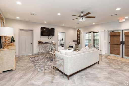A Spacious Living Room With Ceiling Fan at Arbours at Pierce Creek, Mobile, AL