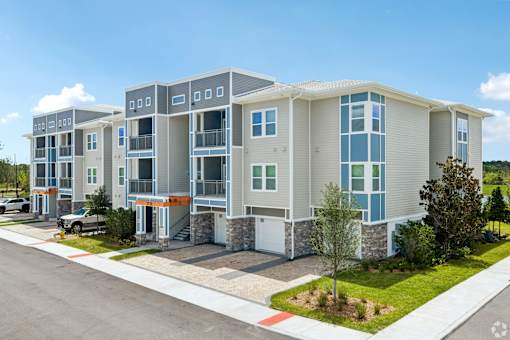 A modern apartment complex with multiple buildings and balconies.