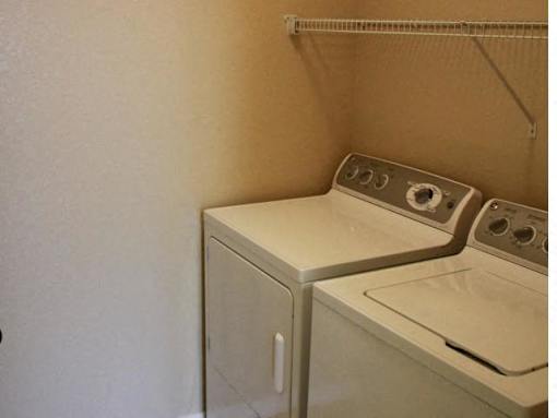 A washer and dryer in a small room at Arbours at Ensley Apartments, Pensacola