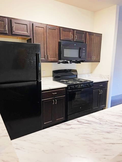 Kitchen with Black Appliances at Arbours at Covington Apartments, Georgia