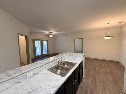 A kitchen with a marble countertop and a sink.