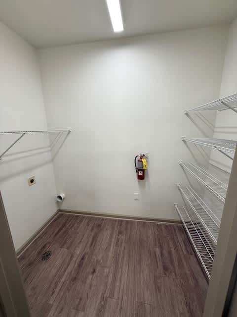 A room with a fire extinguisher on the wall.