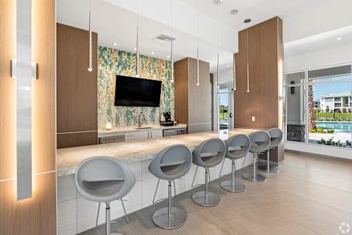 A row of grey chairs are lined up in a room.