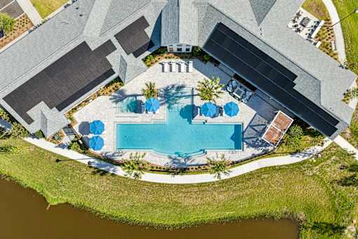 An aerial view of a house with a pool and a patio area.