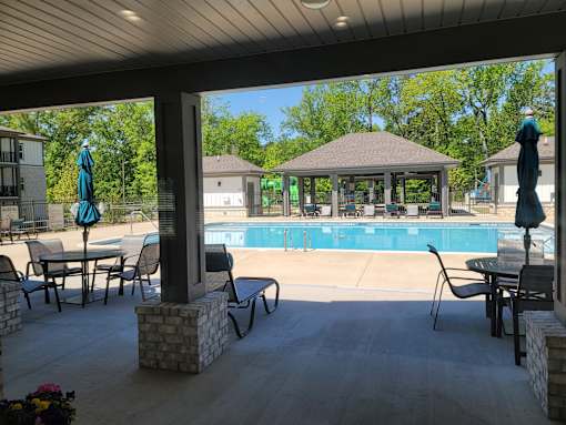A patio with a pool and a gazebo.