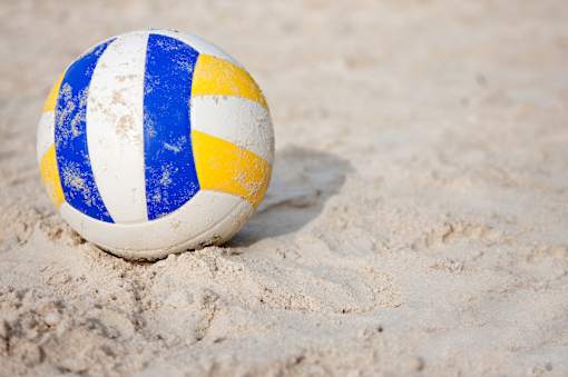 A blue and white striped beach ball sits on the sand at Arbours at Ensley Apartments, Pensacola