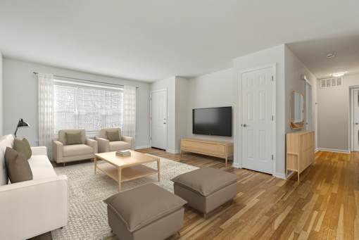 A living room with a white couch, a brown ottoman, a wooden coffee table, and a flat-screen TV. at Chatham Hill, New Jersey, 07928