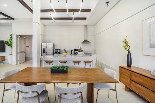 A dining room with a wooden table and chairs at The Addison, Baton Rouge