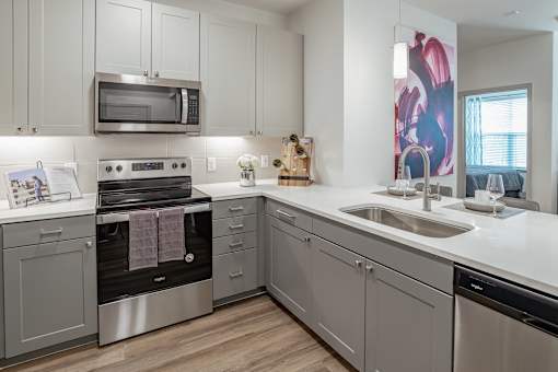 Kitchen with white cabinets at Alys Crossing Apartments, Cypress, Texas