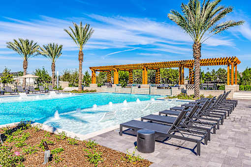 Poolside Sundeck With Relaxing Chairs at Alys Crossing Apartments, Texas