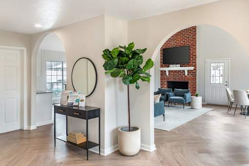A living room with a brick fireplace and a television above it.