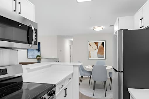 A modern kitchen with a black stove top oven and a black refrigerator.