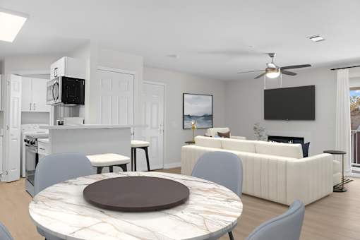A modern living room with a kitchen area in the background.