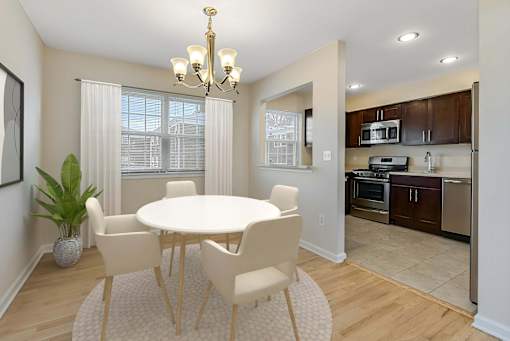 A dining room with a white table and chairs. at Chatham Hill, New Jersey, 07928