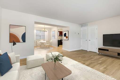 A living room with a white couch, a coffee table, and a painting on the wall. at Chatham Hill, New Jersey, 07928