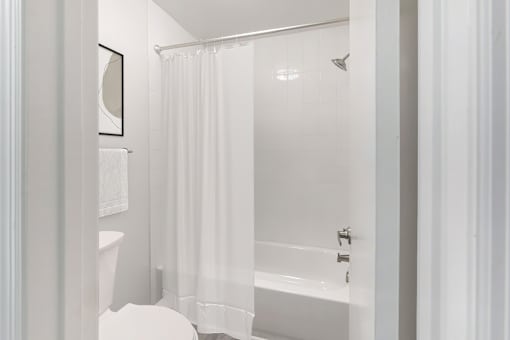 a white bathroom with a shower and a toilet at Riverchase Landing, Alabama