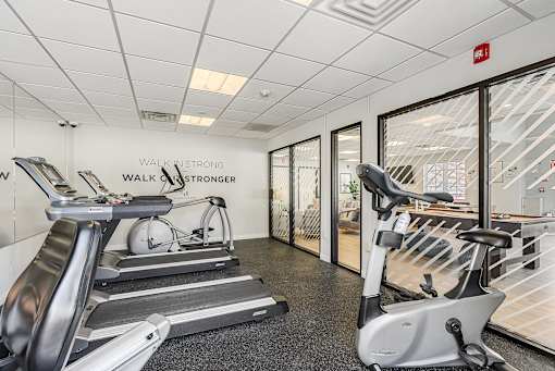 A gym with treadmills and a fire exit sign. at Chatham Hill, New Jersey, 07928