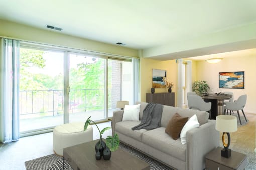 a living room with a couch and a table at Copper and Quarry Village, Pikesville, MD, 21209