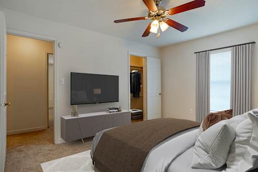 Bedroom with bed, ceiling fan and light at Crosswinds Apartments, Pearl, MS