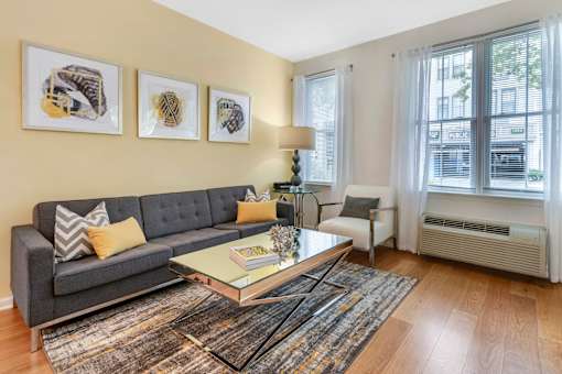 a living room with a couch and a coffee table at Pier Village Apartments, Long Branch, NJ